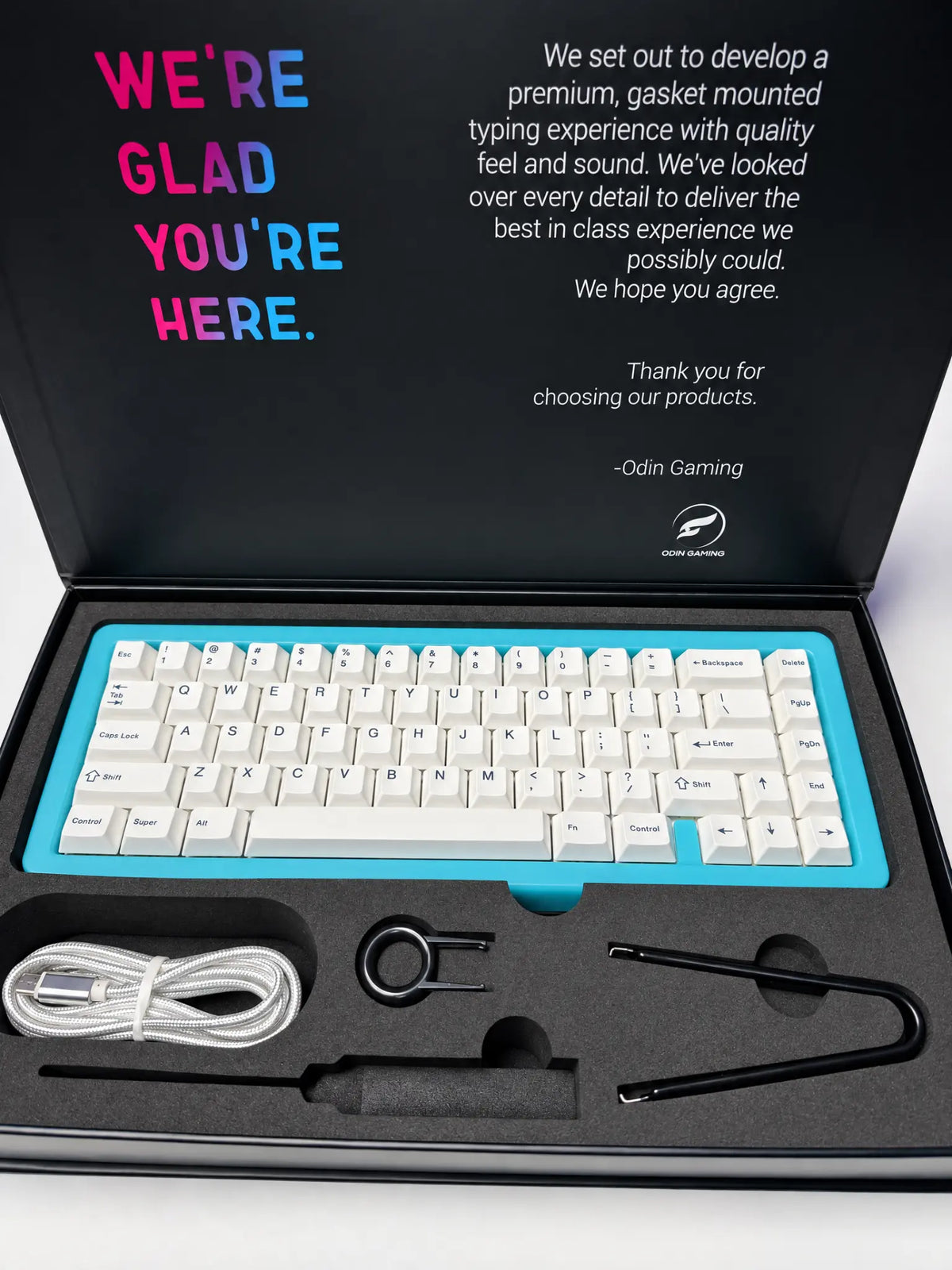 Odin Gaming Aurora65 LITE Nebula Blue keyboard in an open retail box with white keycaps, USB cable, keycap puller and switch puller.