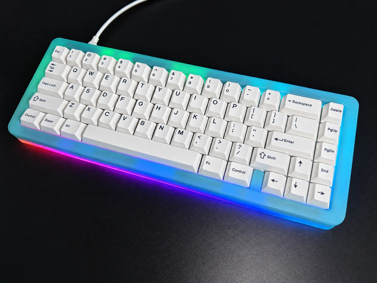 Odin Gaming Aurora65 LITE Nebula Blue fully built keyboard, angled view with installed white keycaps and multicolor RGB underglow.